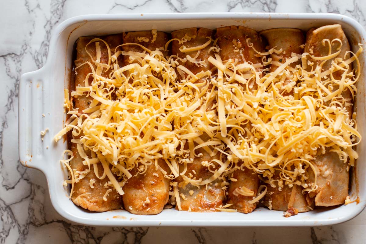 Pulled Pork Enchiladas in a casserole dish ready to bake.