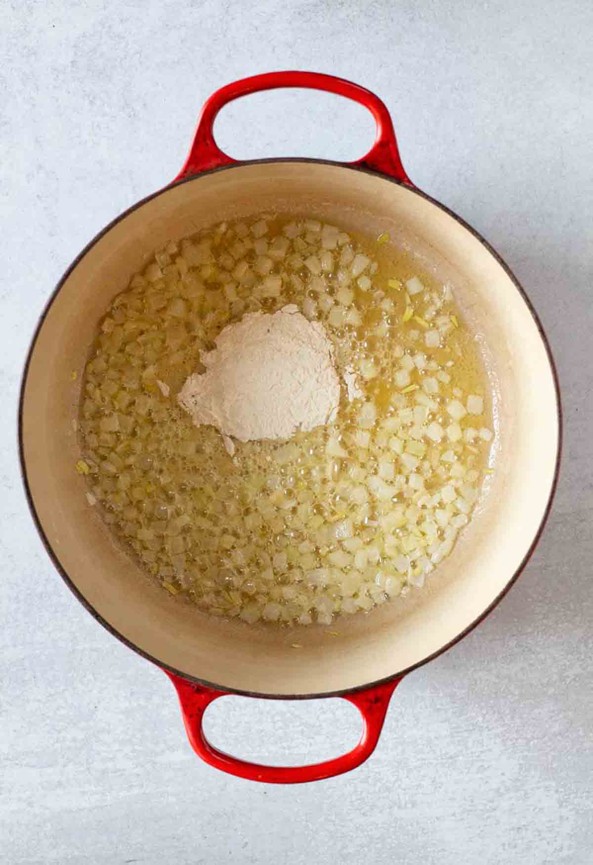 Adding flour to make roux for chipotle mac and cheese.