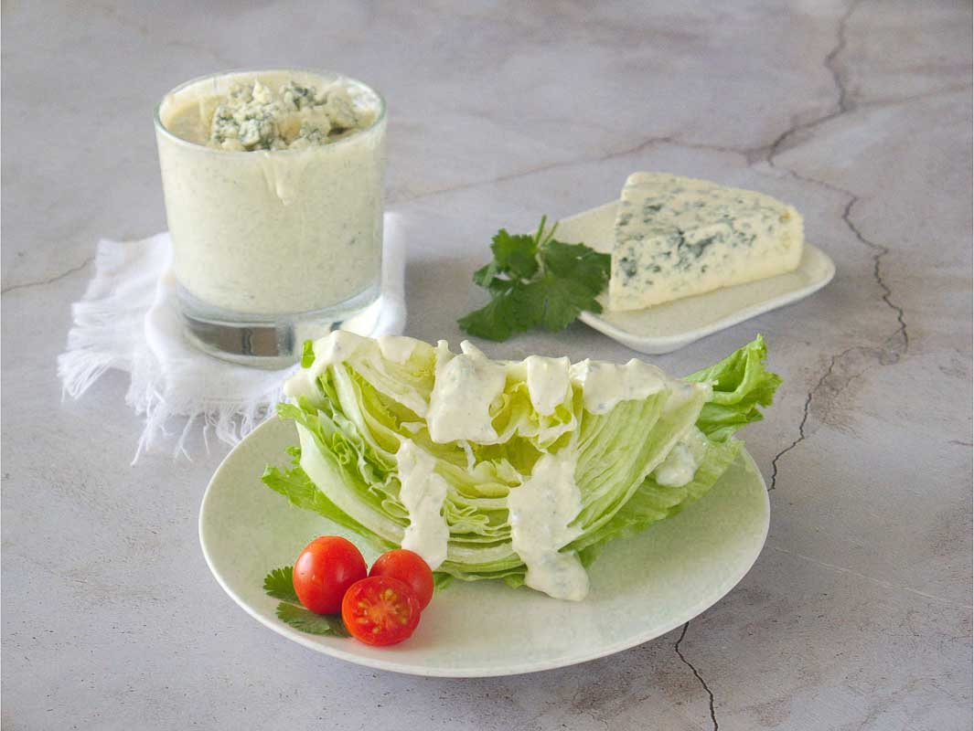 Homemade blue cheese dressing recipe served over a wedge salad.