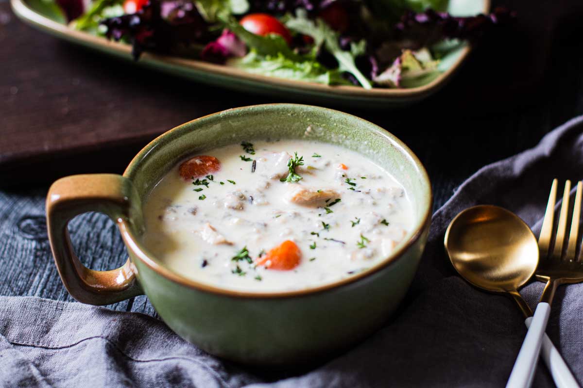 Chicken wild rice soup in a frankhoma soup bowl served with a tossed green salad
