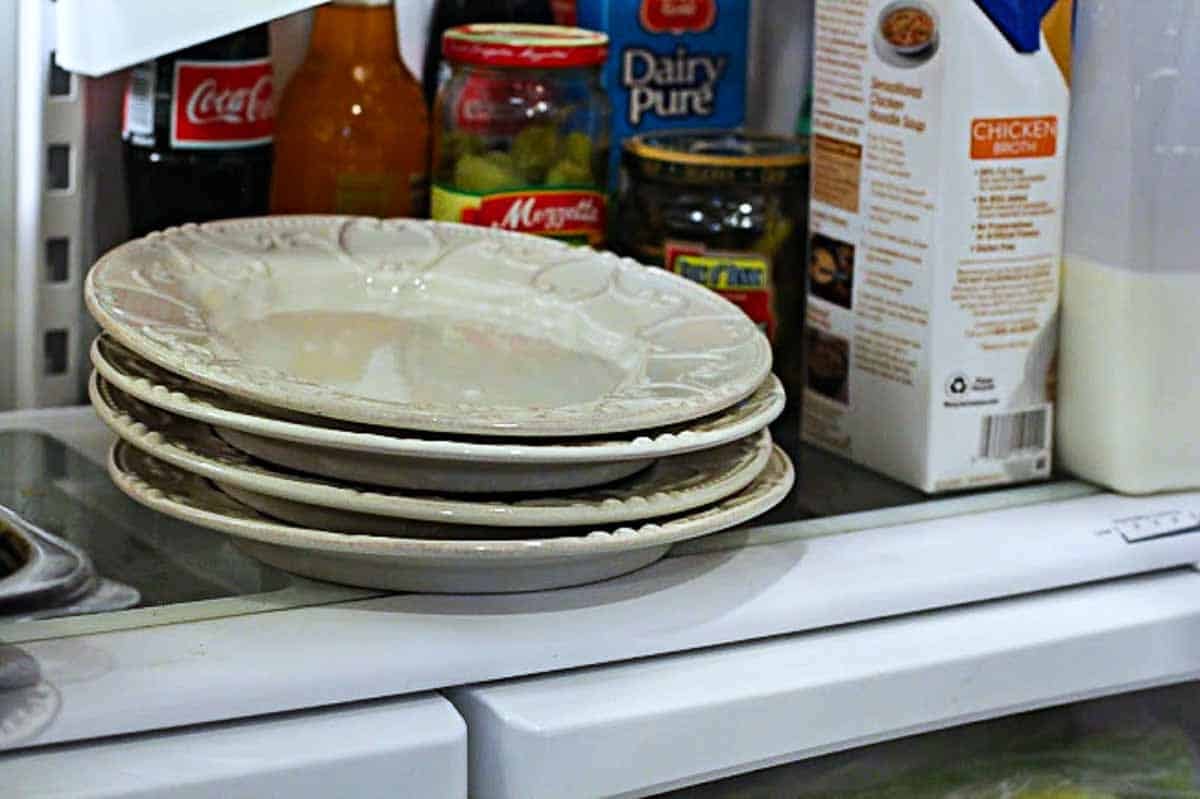 Chilling salad plates to make an accompaniment salad.