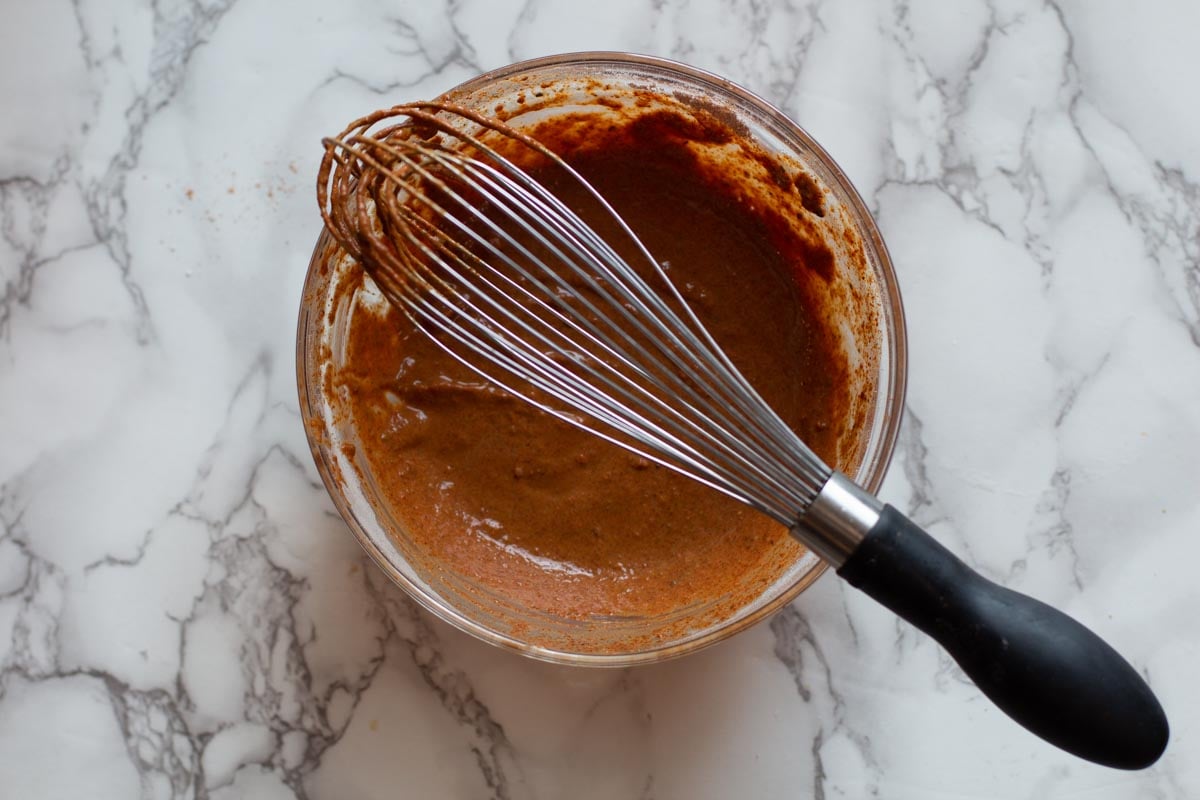 Combining water and dry ingredients to make enchilada from scratch