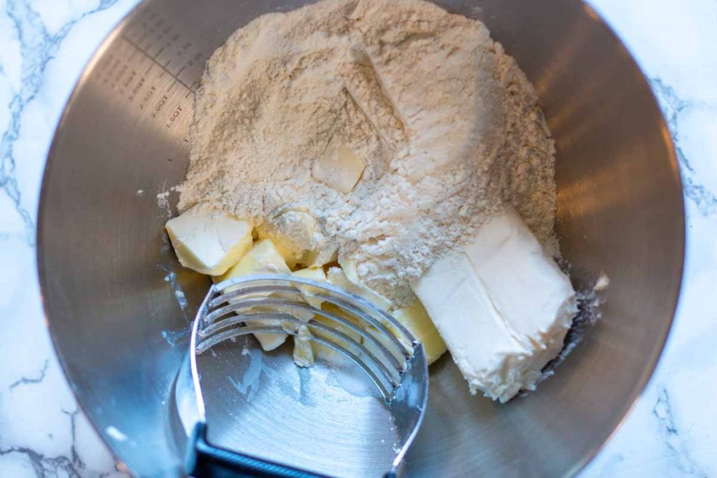 Mixing cream cheese dough to make empanadas