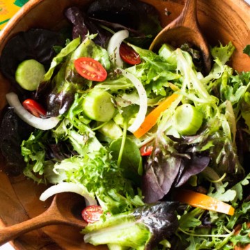 A perfect tossed salad in a wooden salad bowl.