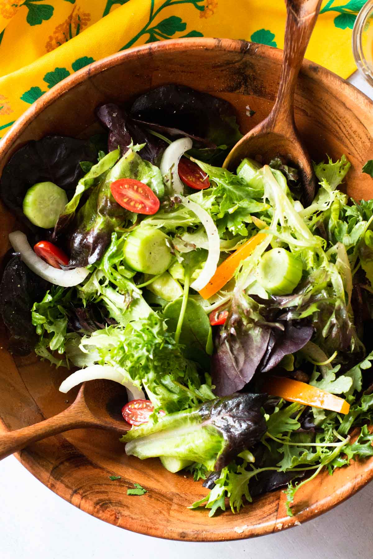 A perfect tossed salad in a wooden salad bowl.