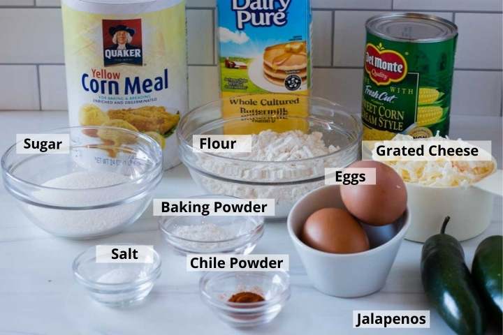 Ingredients to make cheesy cornbread with creamed corn and buttermilk.