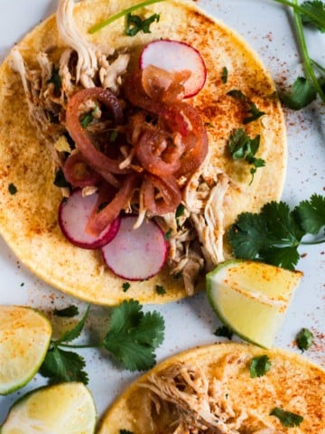 Chicken barbacoa served with corn tortillas and pickled onions.