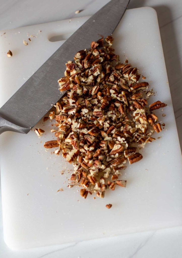 Using a chef knife to chop pecans