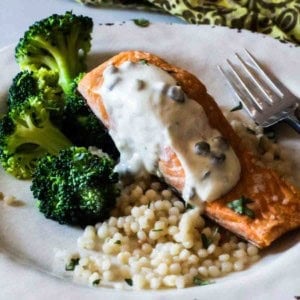 Creamy caper sauce for salmon served over salmon with broccoli.