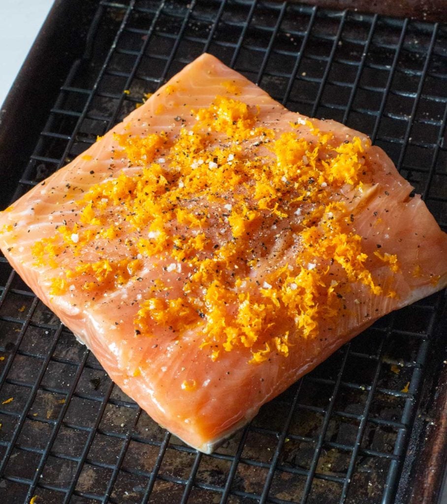 Salmon fillet sprinkled with orange zest salt and pepper to make orange salmon recipe