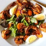 Blackened shrimp over spring greens with cherry tomatoes, hard boiled eggs, bacon and champagne vinaigrette