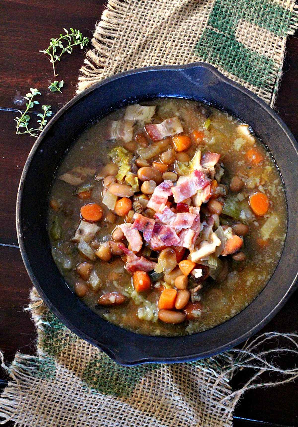 Great northern bean soup with bacon served in a cast iron skillet