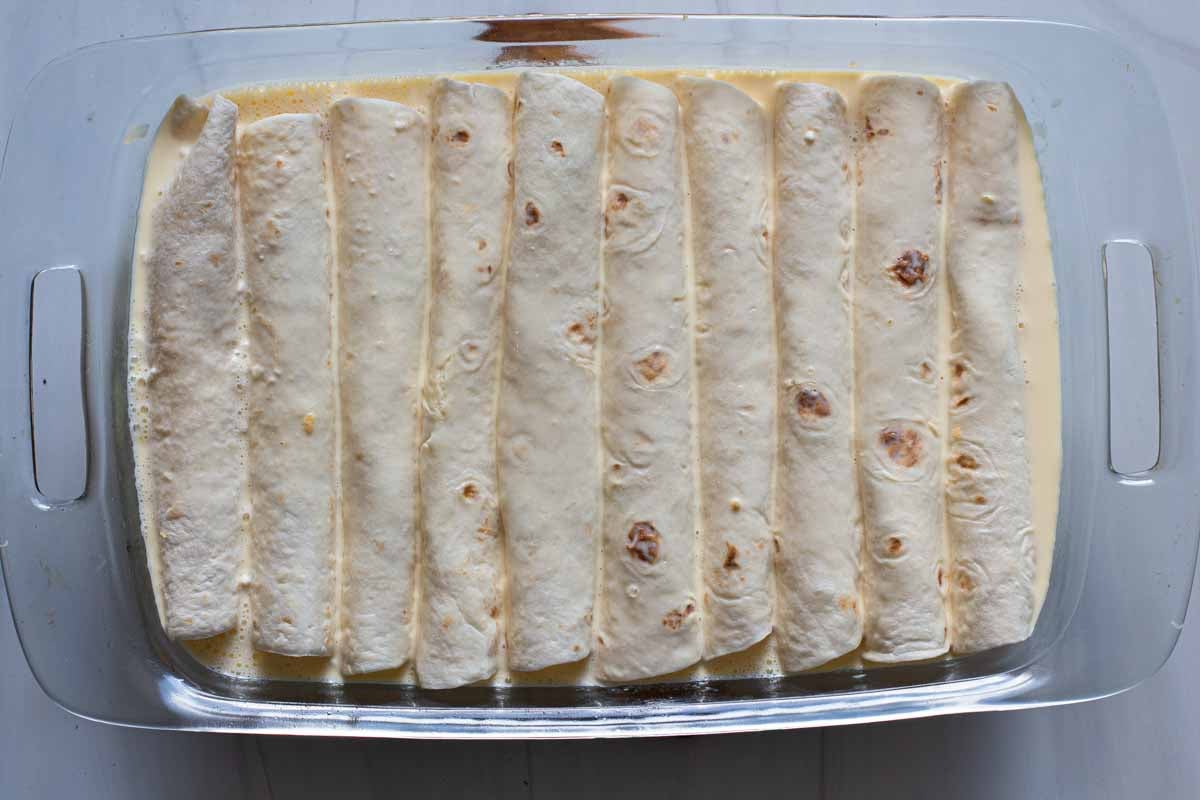 Make ahead breakfast burrito casserole in a pyrex baking dish ready to bake