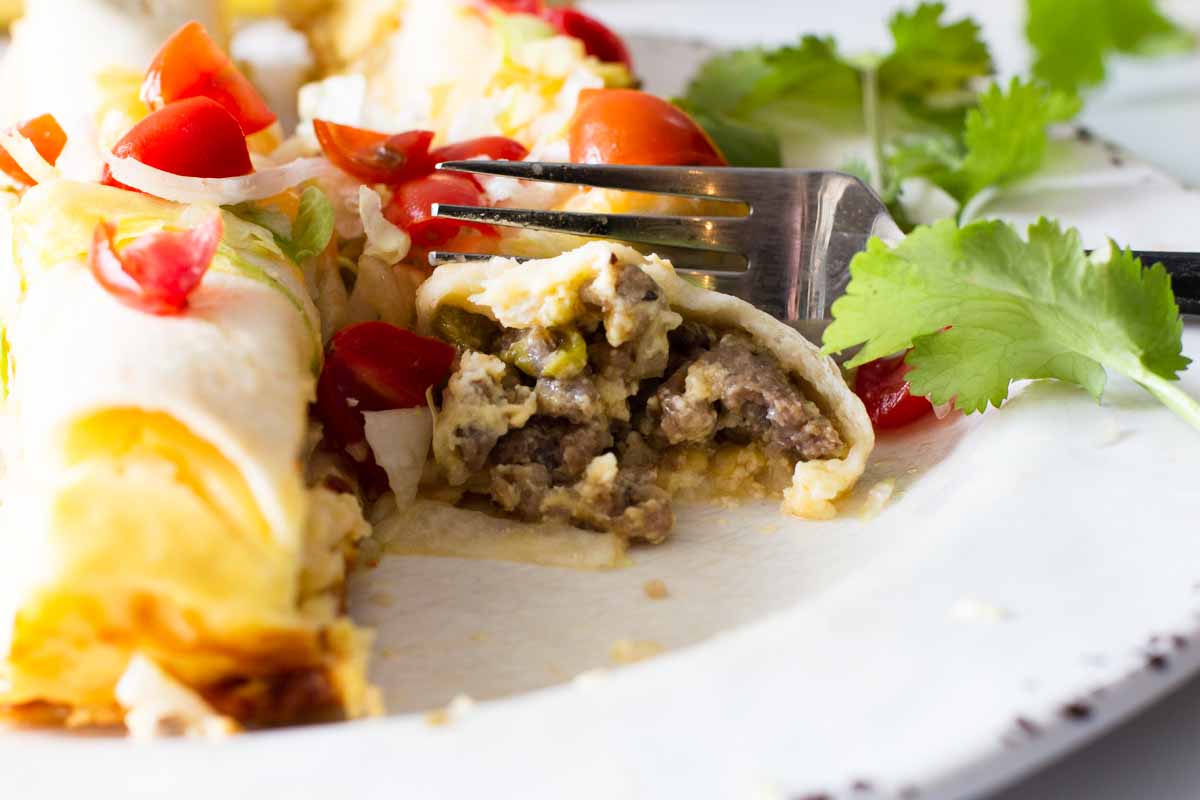 Cutting into a burrito with a fork