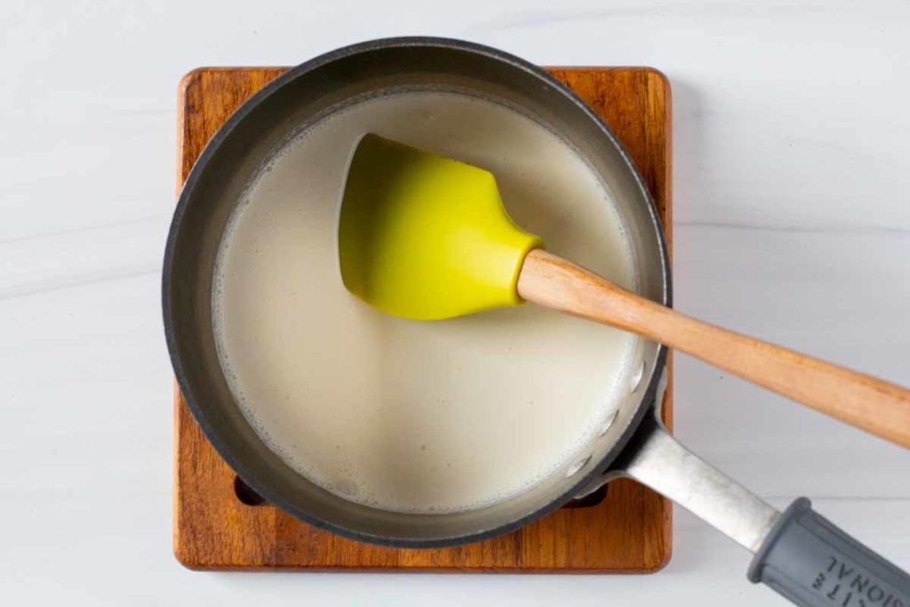 Reducing heaving cream by cooking it on the stovetop in a saucepan