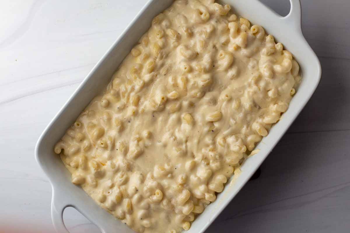 macaroni and cheese in a white Sur la table casserole dish ready to bake