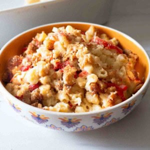 Macaroni and cheese with tomatoes served in a bowl.