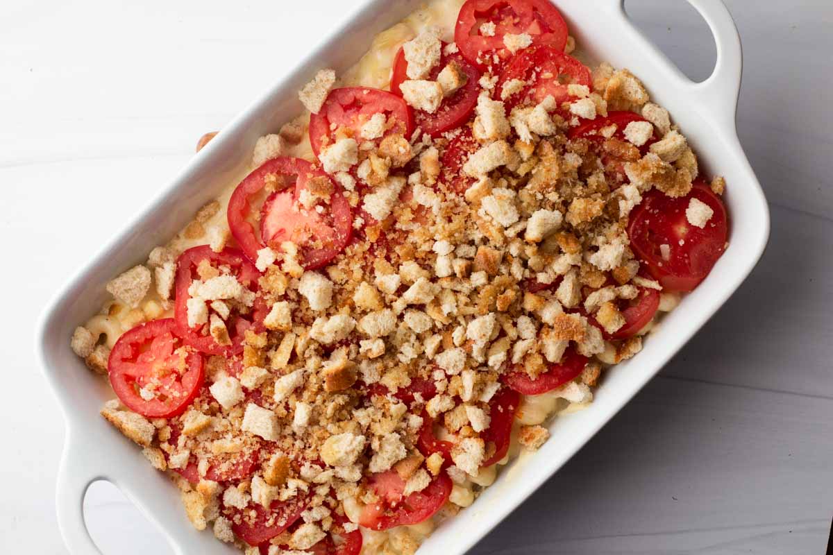 Macaroni and cheese with tomatoes and bread crumbs in a white sur la table casserole dish