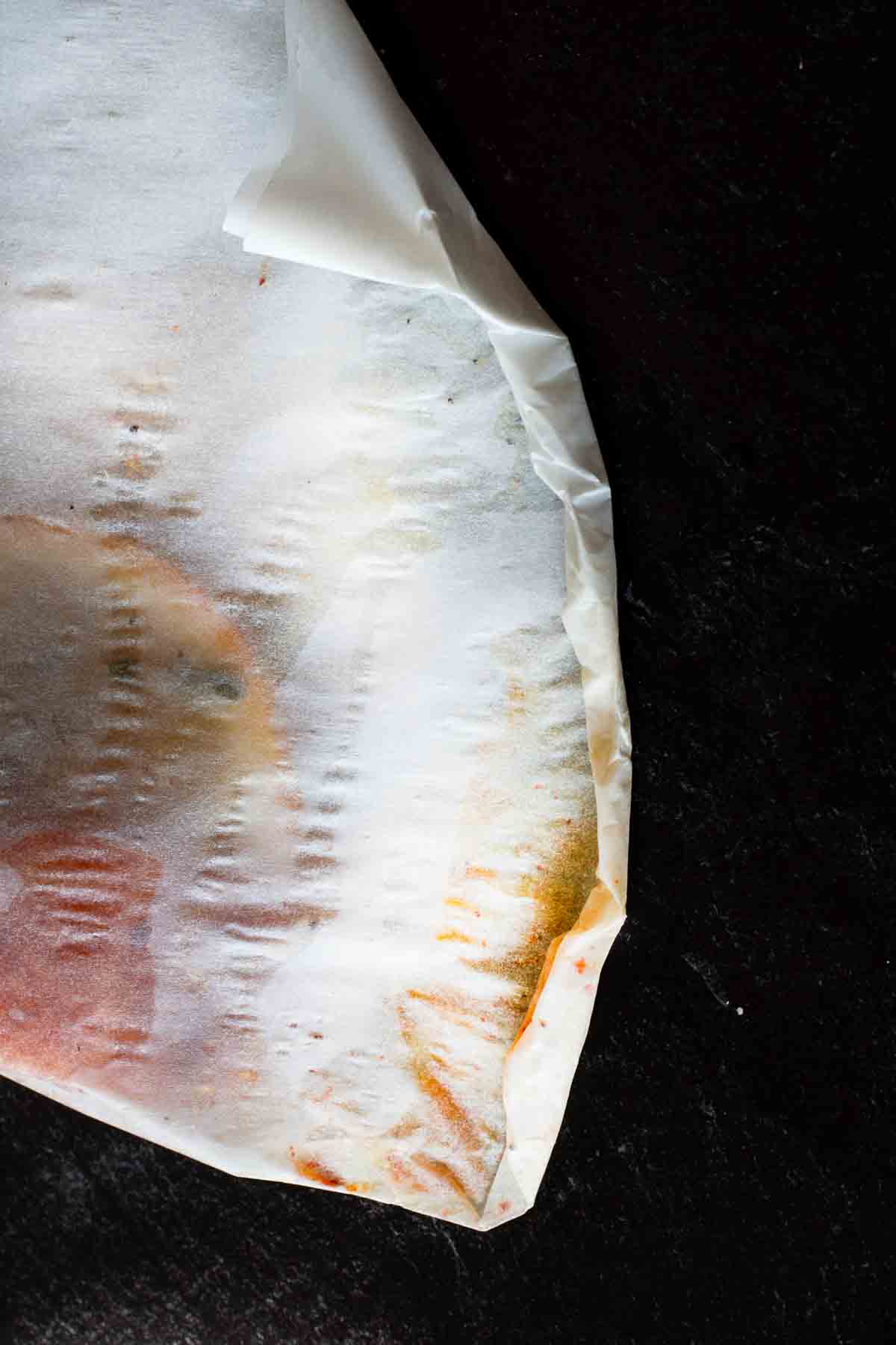 Step 7: crimping edges of parchment paper packet to seal.