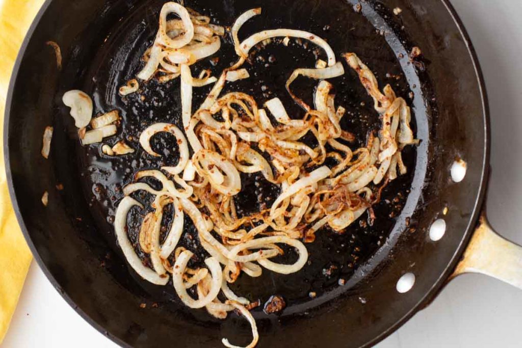 caramelizing onions in a pan stovetop