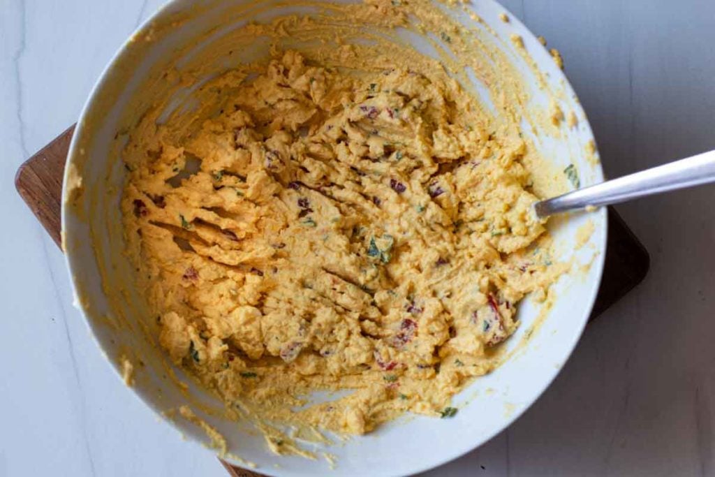 mixing ingredients together to make Mexican Deviled Eggs