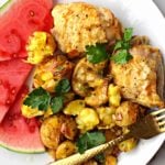 lemon baked chicken thighs served with smashed potatoes and sliced watermelon