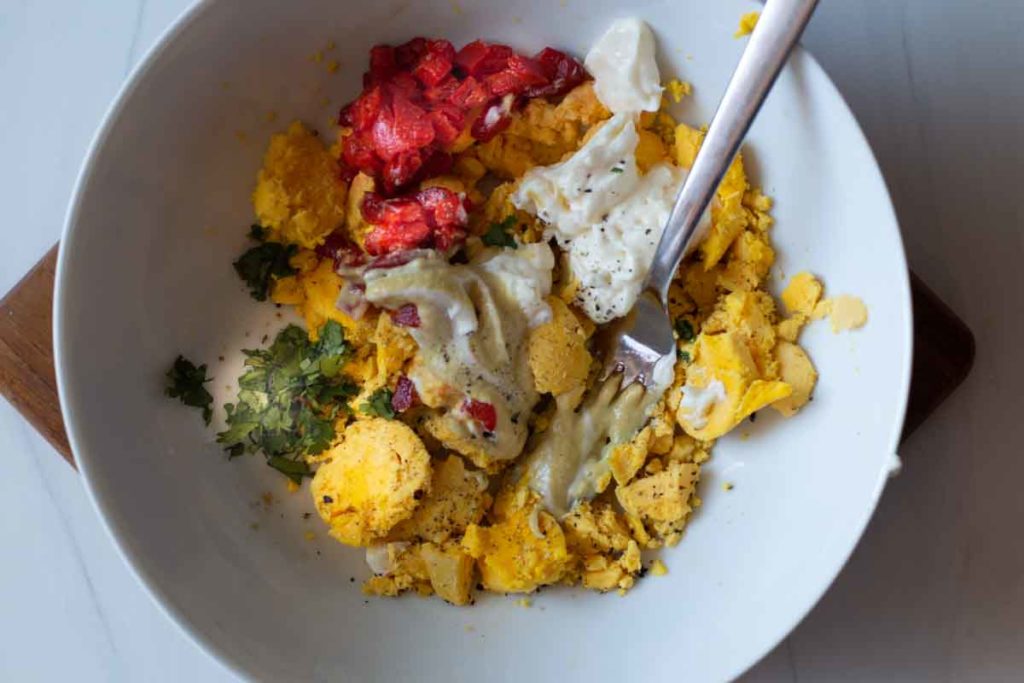 Ingredients to make Mexican Deviled Eggs in a white bowl