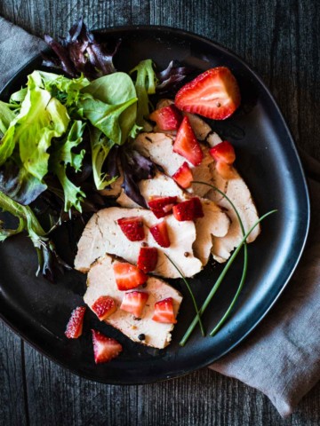 chopped pickled strawberries over grilled pork loin roast with a side salad