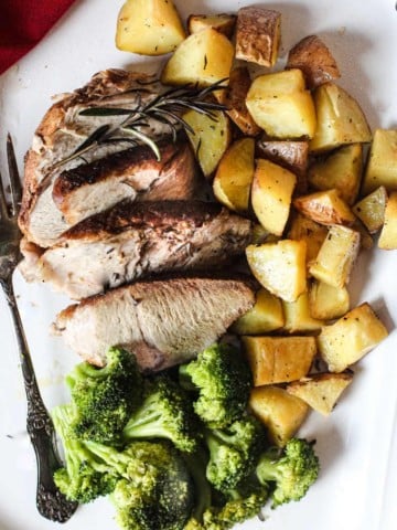 Pork roast thats been cooked in a pressure cooker served with fried potatoes and steamed broccoli.