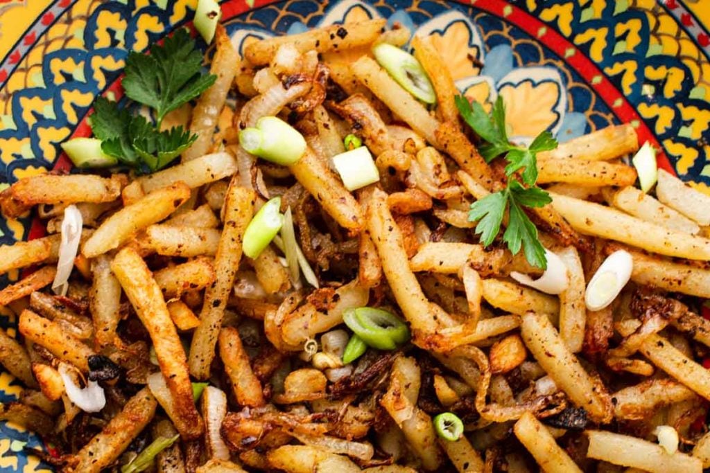 Turkish potatoes topped with green onions and garnished with parsley