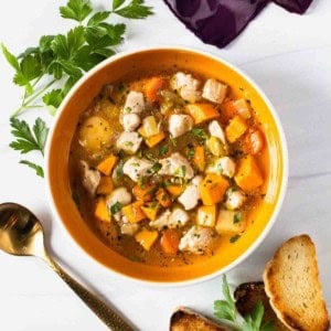 Chicken sweet potato soup served with bread.