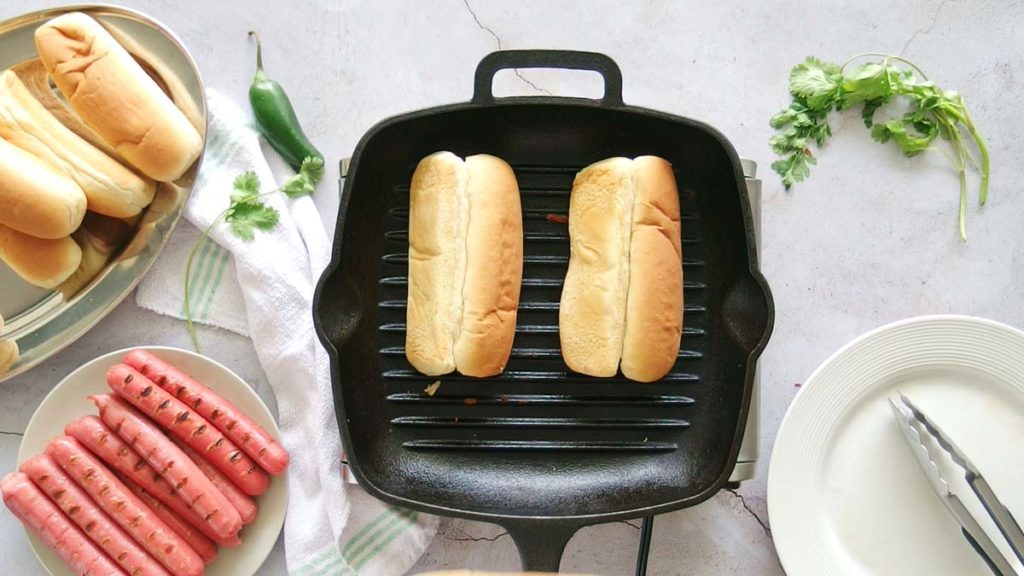 grilling hot dog buns in a stovetop grill pan