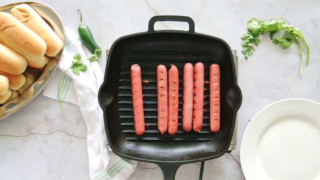 grilling hotdogs in a stovetop grill pan