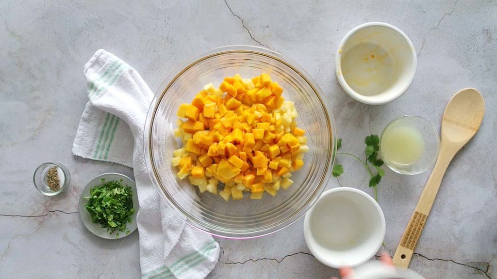 Chopped pineapple and mango in a glass bowl