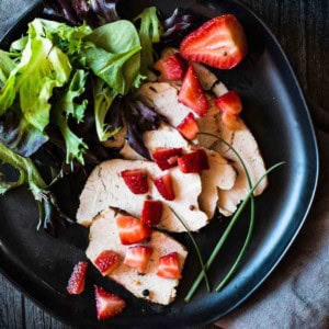 Pickled strawberries served over sliced pork roast.