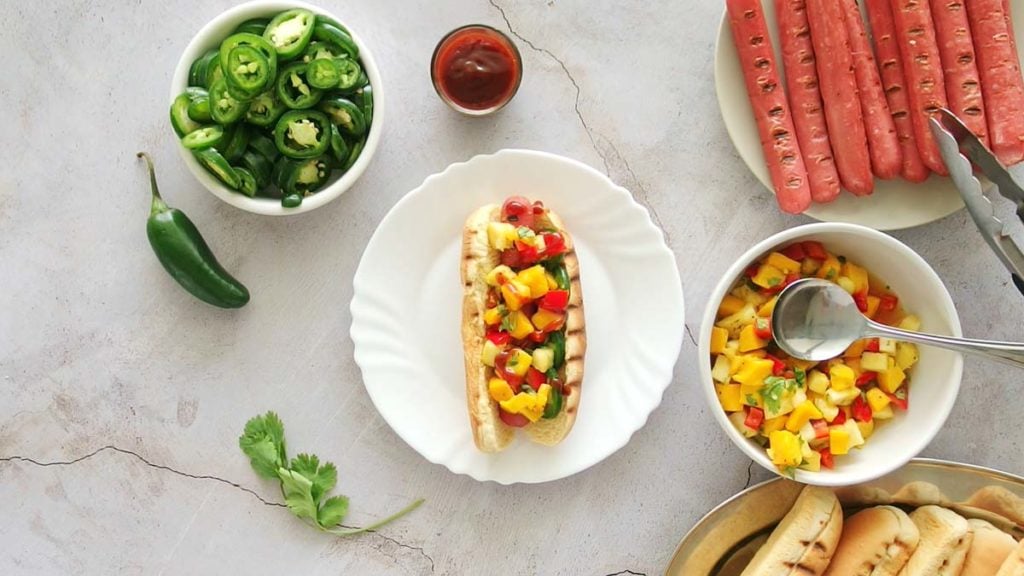 grilled hot dog with mango pineapple salsa and bbq sauce