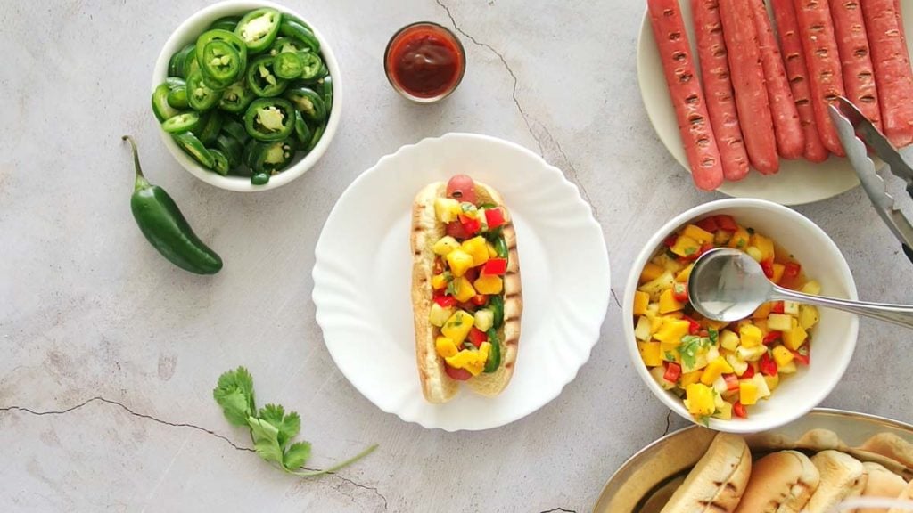 grilled hot dog with mango pineapple salsa and jalapenos