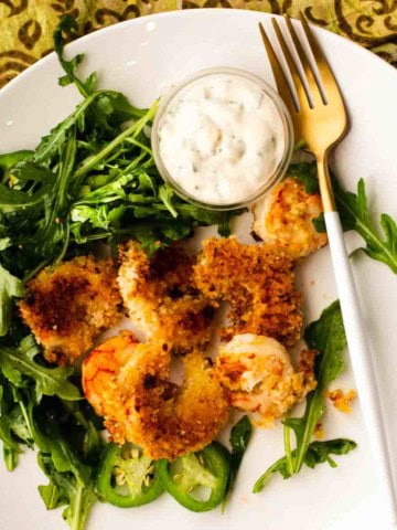 Panko breaded baked shrimp served over arugula.