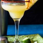 Pineapple Jalapeno Margarita garnished with chile powder and a wedge of fresh pineapple
