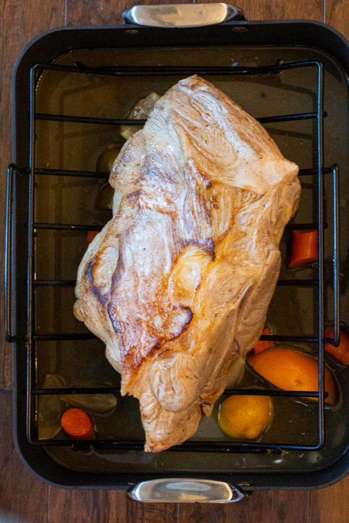 A pork should butt roast in a roaster pan ready for the oven