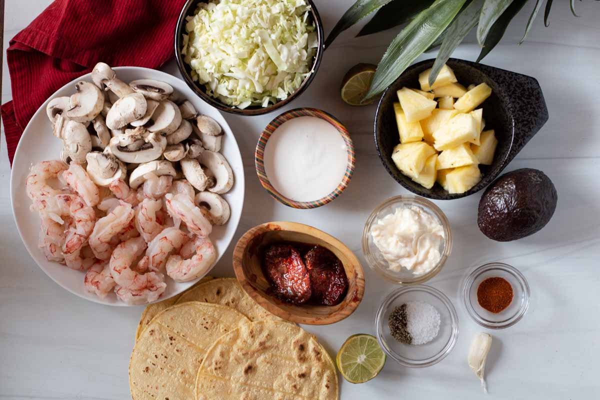 Shrimp taco ingredients to make easy shrimp tacos with corn tortillas.