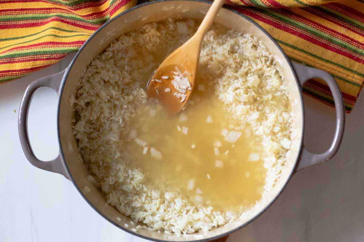 adding chicken broth to oven rice