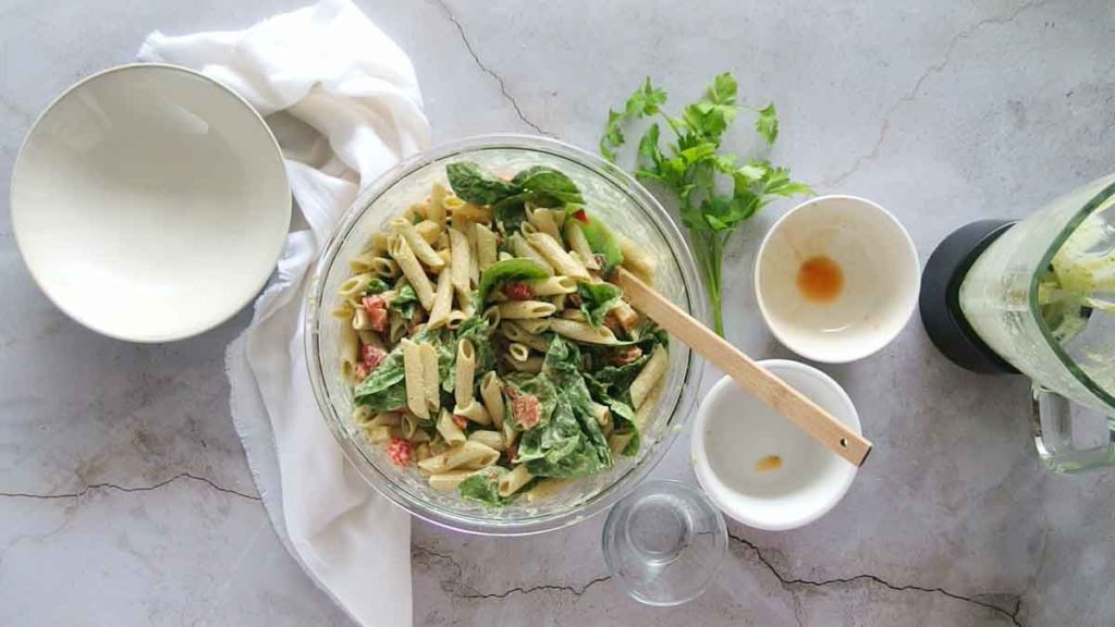 Mixing all ingredients to make whole foods smoked mozzarella pasta