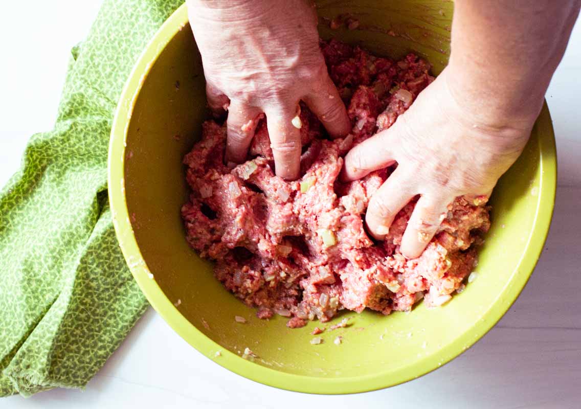 mixing meatloaf by hand to form a loaf