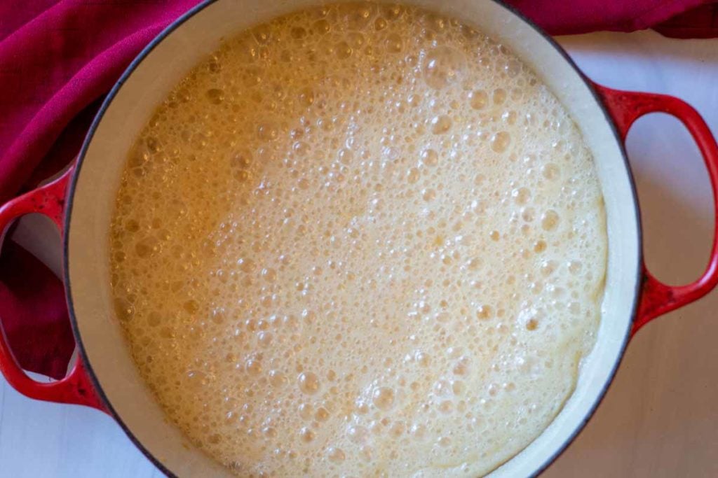 Boiling sugar, condensed milk and butter to make old fashioned fudge