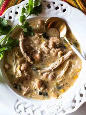 Rotisserie chicken soup served in a white bowl garnished with cilantro.