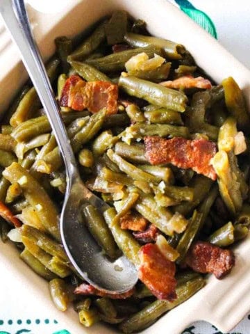 Brown sugar green beans with bacon in a casserole dish.
