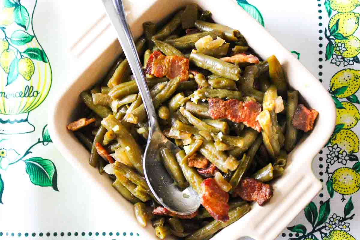 Brown sugar green beans with bacon in a casserole dish, using canned beans.