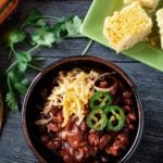 Cowboy chili topped with sliced jalapenos and grated cheddar cheese