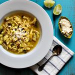 Chicken poblano soup with hominy and limes